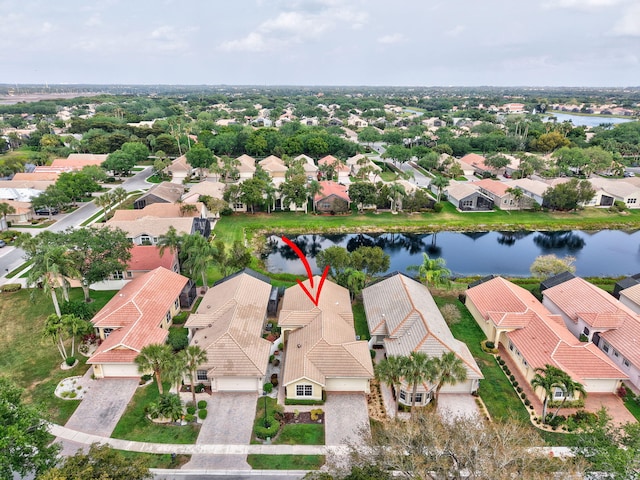 birds eye view of property with a residential view and a water view