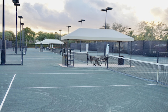 view of tennis court featuring fence