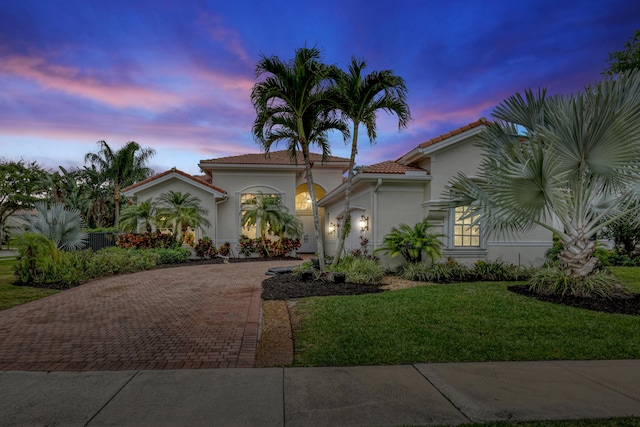 8888 Rockridge Glen Cv, Boynton Beach, FL 33473 - mediterranean / spanish house featuring decorative driveway, a garage, a tile roof, a front lawn, and stucco siding