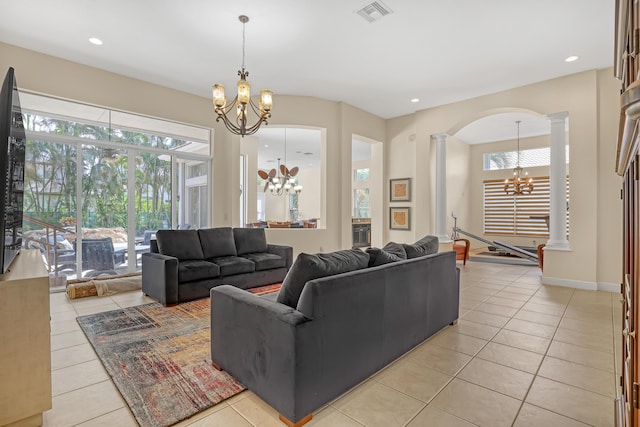 8888 Rockridge Glen Cv, Boynton Beach, FL 33473 - living area with ornate columns, a wealth of natural light, a notable chandelier, and visible vents
