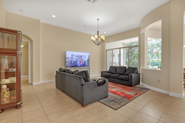 8888 Rockridge Glen Cv, Boynton Beach, FL 33473 - living area featuring baseboards, arched walkways, and light tile patterned floors