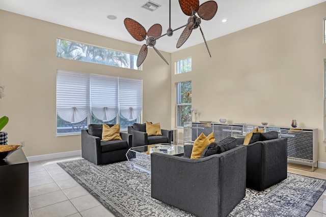 8888 Rockridge Glen Cv, Boynton Beach, FL 33473 - living room with a high ceiling, light tile patterned floors, baseboards, visible vents, and ceiling fan