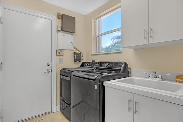 8888 Rockridge Glen Cv, Boynton Beach, FL 33473 - laundry room featuring light tile patterned flooring, cabinet space, a sink, and washer and clothes dryer