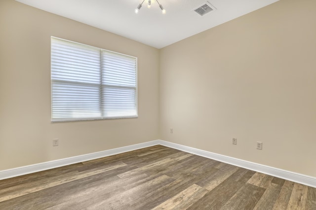 8888 Rockridge Glen Cv, Boynton Beach, FL 33473 - unfurnished room featuring baseboards, visible vents, and dark wood finished floors