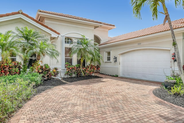 8888 Rockridge Glen Cv, Boynton Beach, FL 33473 - mediterranean / spanish-style home with a tiled roof, decorative driveway, stucco siding, and an attached garage