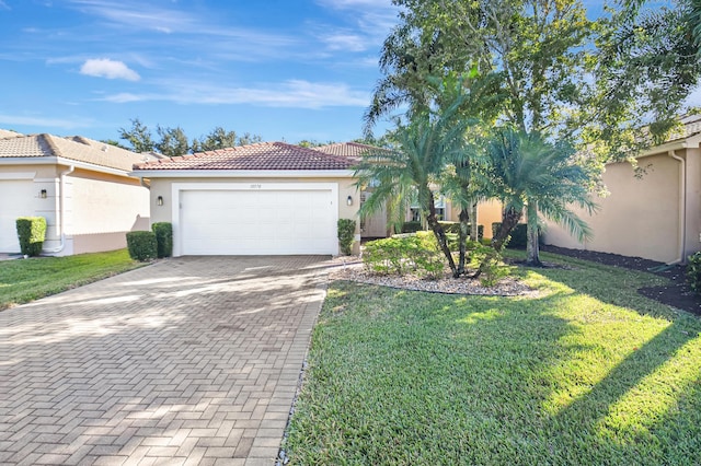 10570 Stone Garden Dr, Boynton Beach, FL 33473 - ranch-style home featuring a tiled roof, decorative driveway, a garage, a front lawn, and stucco siding