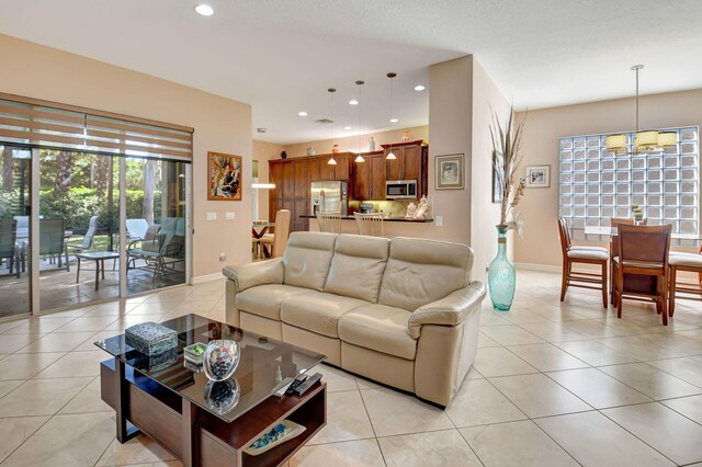 10570 Stone Garden Dr, Boynton Beach, FL 33473 - living room with light tile patterned floors, baseboards, a chandelier, and recessed lighting