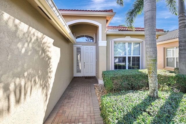 10570 Stone Garden Dr, Boynton Beach, FL 33473 - entrance to property with stucco siding and a tile roof
