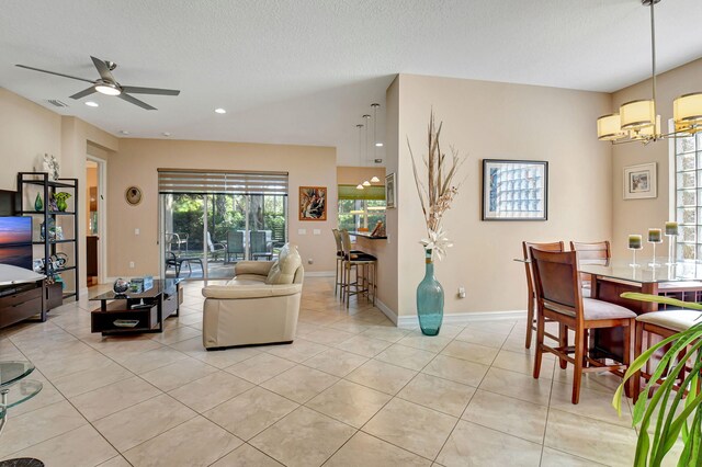 10570 Stone Garden Dr, Boynton Beach, FL 33473 - living room with a textured ceiling, baseboards, light tile patterned floors, ceiling fan with notable chandelier, and recessed lighting