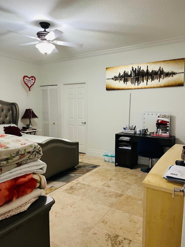 bedroom with a desk, a closet, ceiling fan, and crown molding