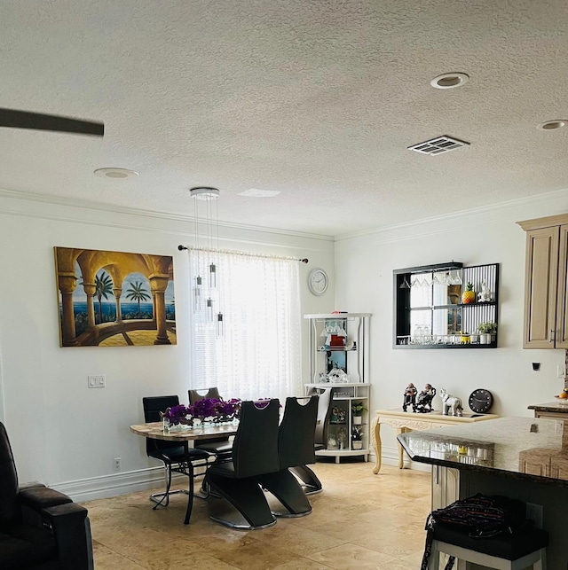 dining space with ornamental molding, a textured ceiling, and baseboards