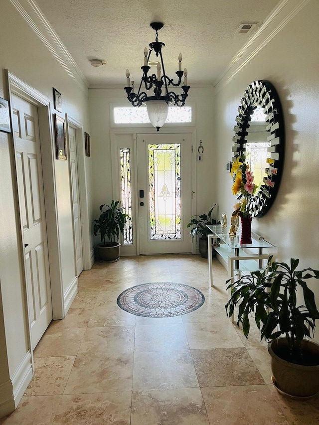 foyer entrance featuring a chandelier, crown molding, a textured ceiling, and baseboards