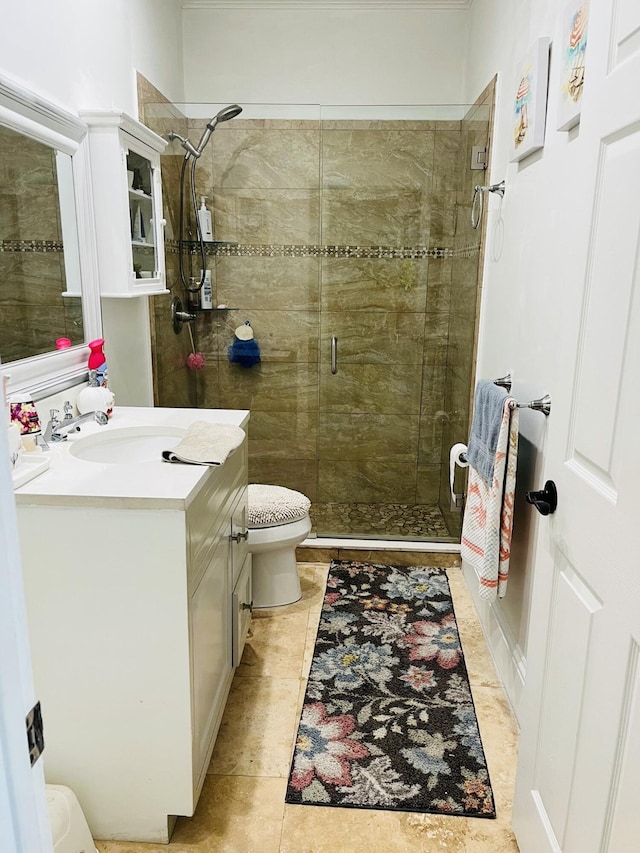 bathroom with a shower stall, vanity, toilet, and tile patterned floors