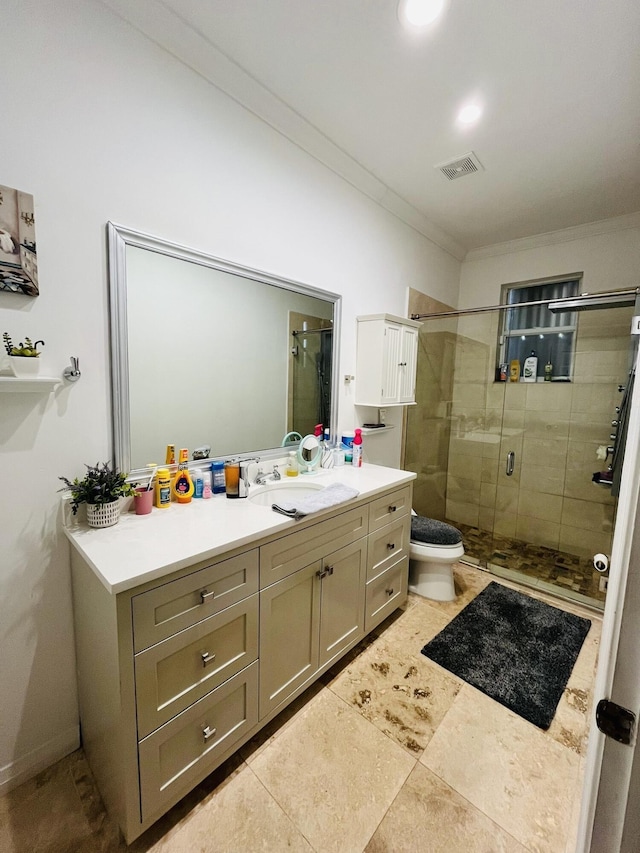 full bathroom featuring a stall shower, vanity, ornamental molding, and toilet