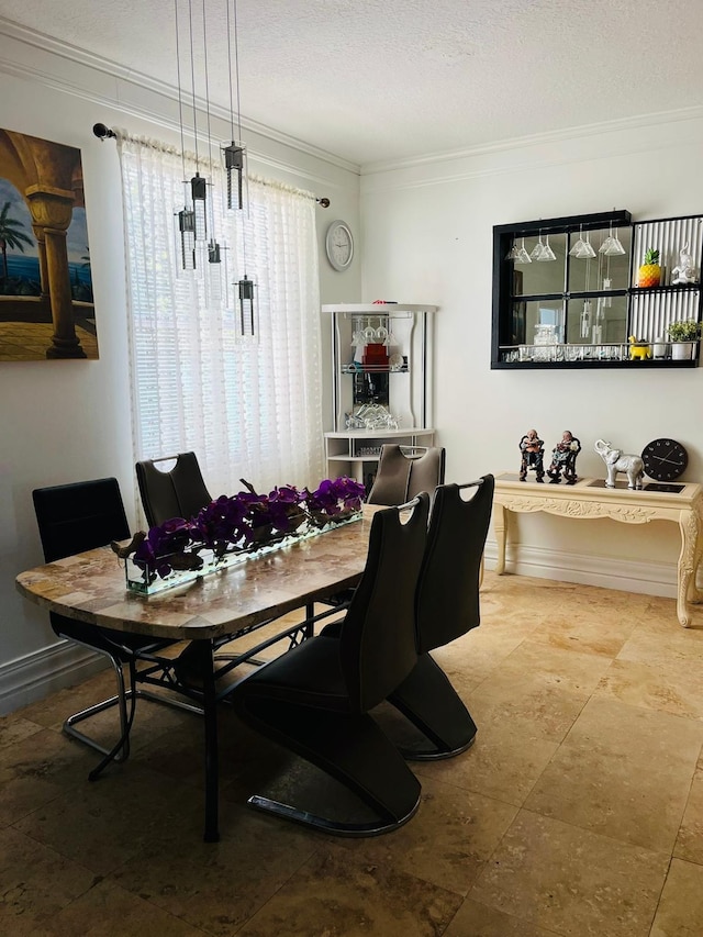 dining space with ornamental molding and a textured ceiling