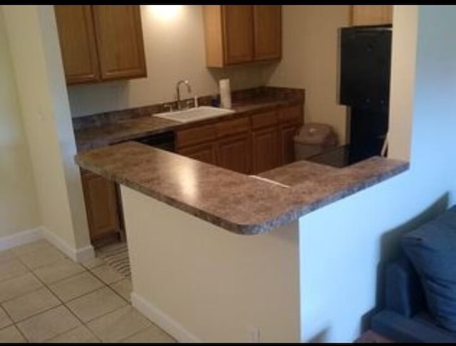 6020 Indrio Rd Unit 6, Fort Pierce, FL 34950 - kitchen featuring baseboards, a peninsula, a sink, and light tile patterned floors