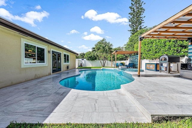 14283 Joan Dr, Palm Beach Gardens, FL 33410 - view of pool with a patio area, a fenced backyard, a pool with connected hot tub, and french doors
