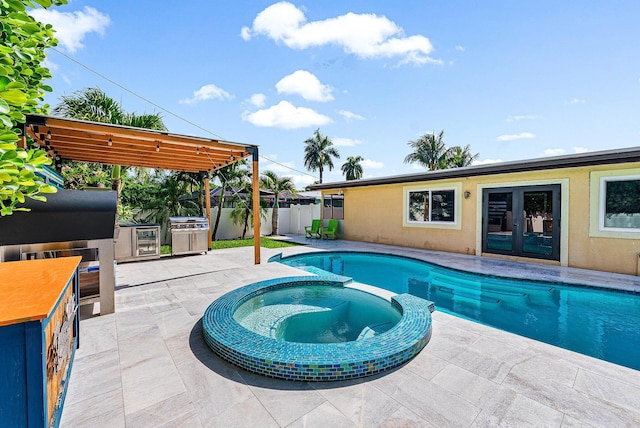 14283 Joan Dr, Palm Beach Gardens, FL 33410 - view of pool with french doors, a patio area, a pool with connected hot tub, and a fenced backyard