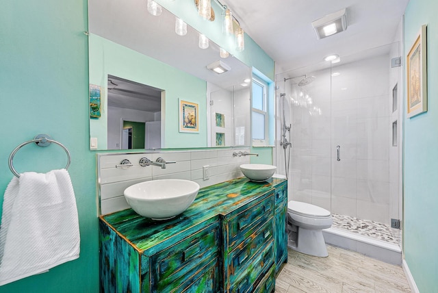 14283 Joan Dr, Palm Beach Gardens, FL 33410 - full bathroom with a shower stall, double vanity, backsplash, and wood finished floors