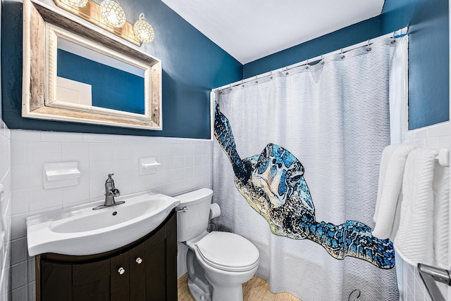 14283 Joan Dr, Palm Beach Gardens, FL 33410 - full bath with vanity, tile walls, wainscoting, and wood finished floors