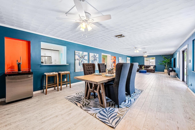 14283 Joan Dr, Palm Beach Gardens, FL 33410 - dining area featuring a ceiling fan, wood finished floors, and ornamental molding