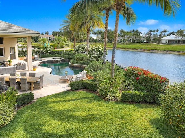 2990 Twin Oaks Way, Wellington, FL 33414 - view of pool featuring a lawn, a water view, a pool with connected hot tub, and a patio area