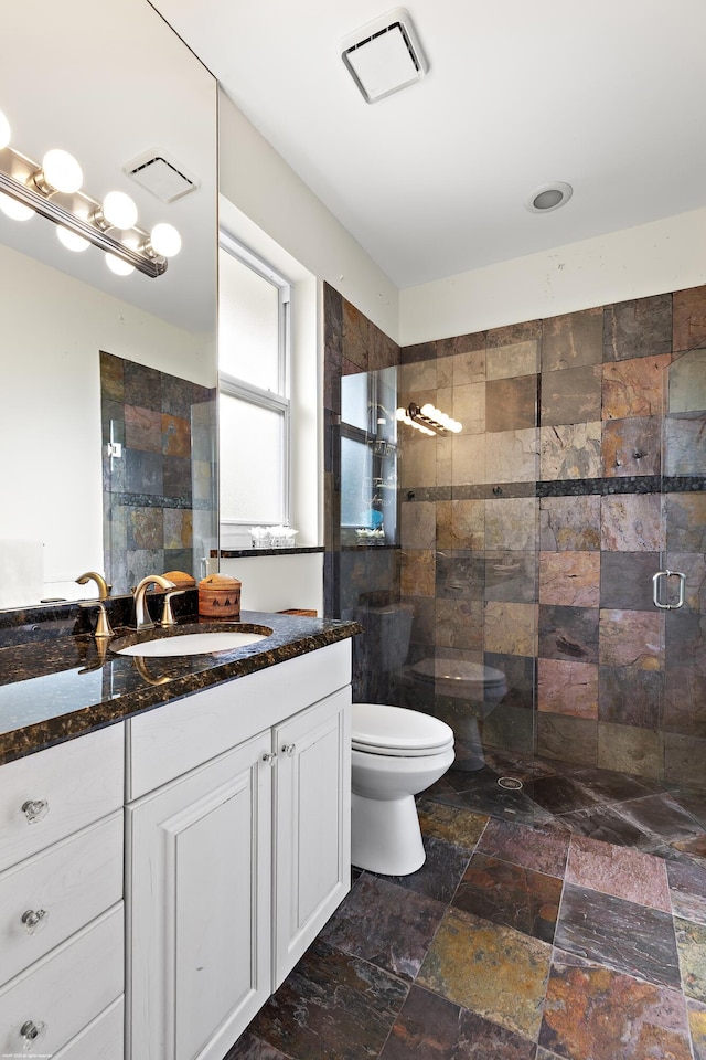 2990 Twin Oaks Way, Wellington, FL 33414 - full bath with stone finish floor, a stall shower, toilet, and visible vents