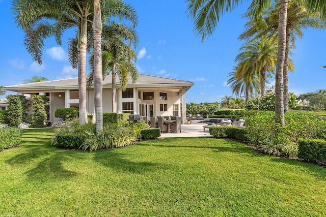 2990 Twin Oaks Way, Wellington, FL 33414 - rear view of house with a lawn, a patio area, and stucco siding