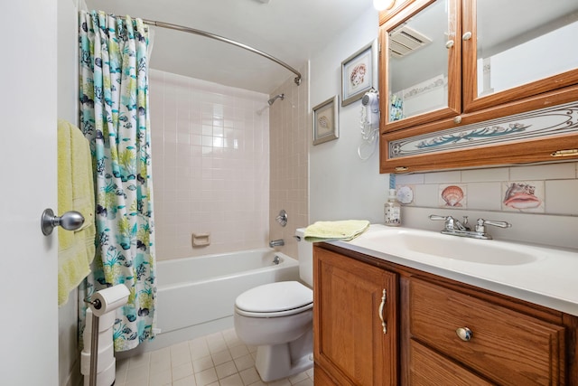 bathroom featuring toilet, tile patterned flooring, vanity, and shower / bath combo with shower curtain