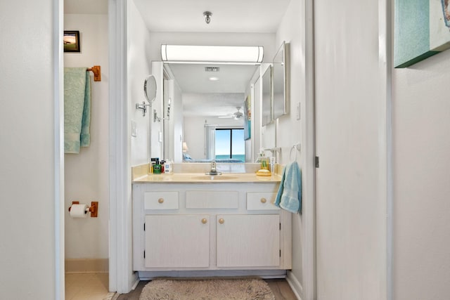bathroom featuring baseboards, visible vents, vanity, and a ceiling fan