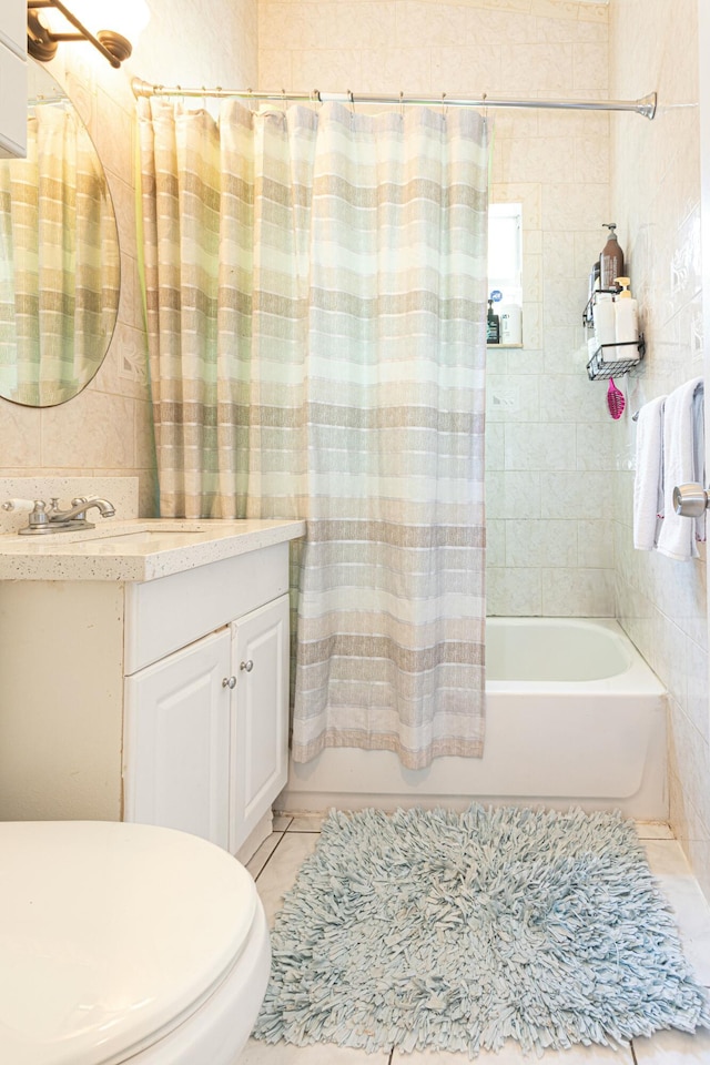 3899 Tuskegee Dr, Lake Worth, FL 33462 - bathroom with vanity, shower / bath combo with shower curtain, toilet, tile patterned floors, and tile walls