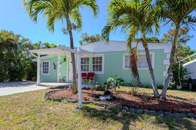 3899 Tuskegee Dr, Lake Worth, FL 33462 - view of front of property featuring stucco siding and a front lawn