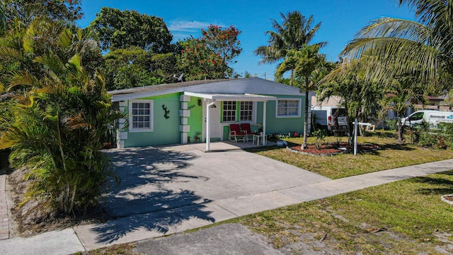 3899 Tuskegee Dr, Lake Worth, FL 33462 - view of front of house featuring concrete driveway and a front yard