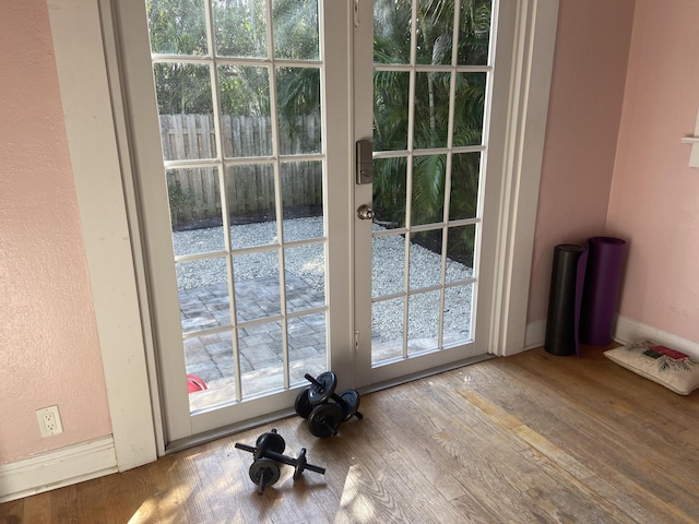 220 Malverne Rd, West Palm Beach, FL 33405 - doorway to outside featuring a healthy amount of sunlight and wood finished floors