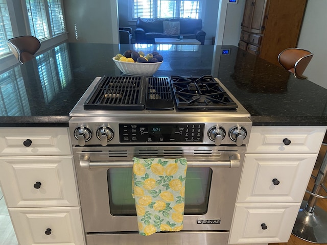 220 Malverne Rd, West Palm Beach, FL 33405 - kitchen with white cabinets, high end range, and dark stone countertops