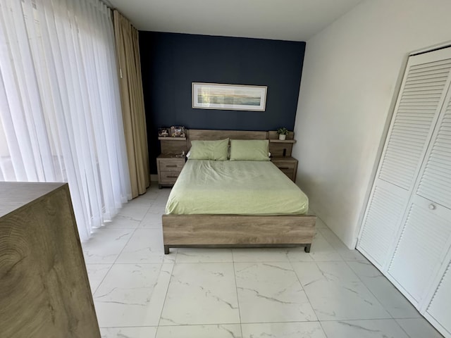 bedroom featuring marble finish floor