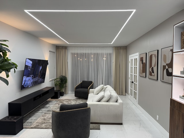 living room with baseboards and marble finish floor