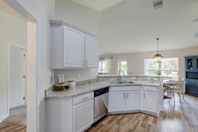 134 Day Dr, Sebastian, FL 32958 - kitchen with a sink, white cabinetry, dishwasher, visible vents, and light wood-style floors