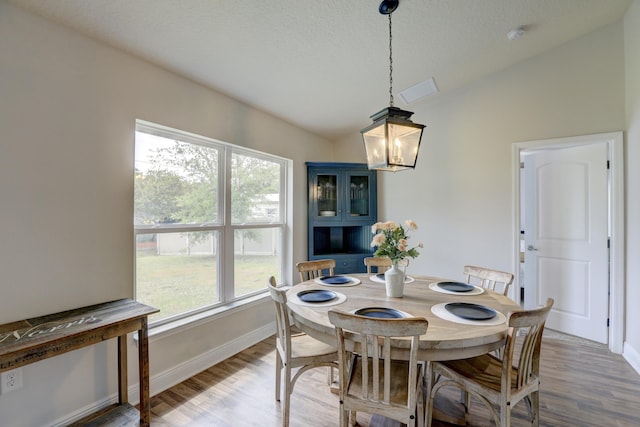 134 Day Dr, Sebastian, FL 32958 - dining room with baseboards, lofted ceiling, a chandelier, and light wood finished floors