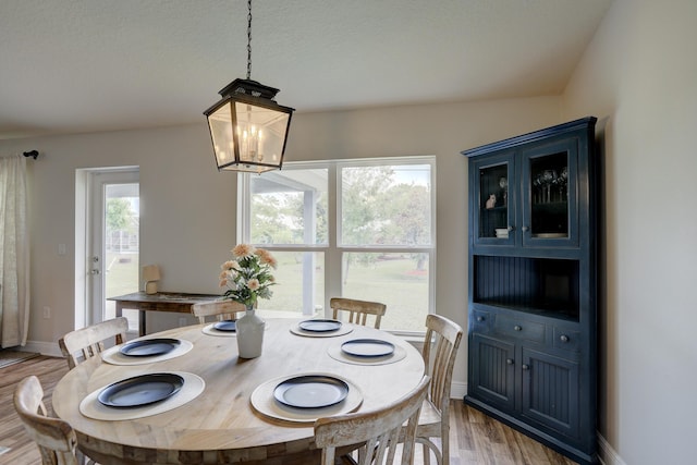 134 Day Dr, Sebastian, FL 32958 - dining space with baseboards, light wood-style flooring, and a chandelier