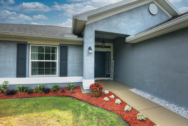 134 Day Dr, Sebastian, FL 32958 - entrance to property featuring a yard, stucco siding, and roof with shingles