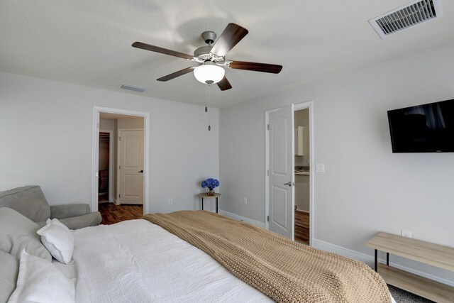 134 Day Dr, Sebastian, FL 32958 - bedroom with baseboards, visible vents, a ceiling fan, and wood finished floors