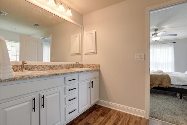 134 Day Dr, Sebastian, FL 32958 - full bath featuring baseboards, visible vents, wood finished floors, and a sink