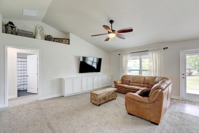 134 Day Dr, Sebastian, FL 32958 - carpeted living area featuring baseboards, lofted ceiling, ceiling fan, and a wealth of natural light