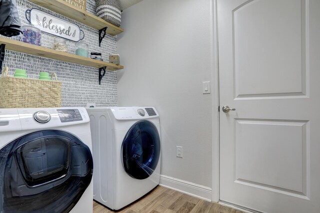 134 Day Dr, Sebastian, FL 32958 - washroom featuring independent washer and dryer, light wood-style flooring, laundry area, and baseboards