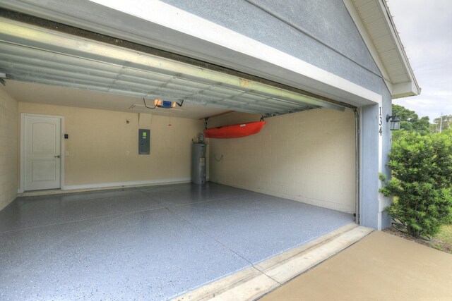 134 Day Dr, Sebastian, FL 32958 - garage featuring water heater, a garage door opener, electric panel, and concrete block wall