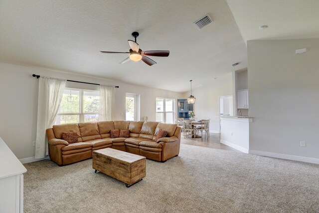 134 Day Dr, Sebastian, FL 32958 - living room featuring light colored carpet, plenty of natural light, ceiling fan, and visible vents