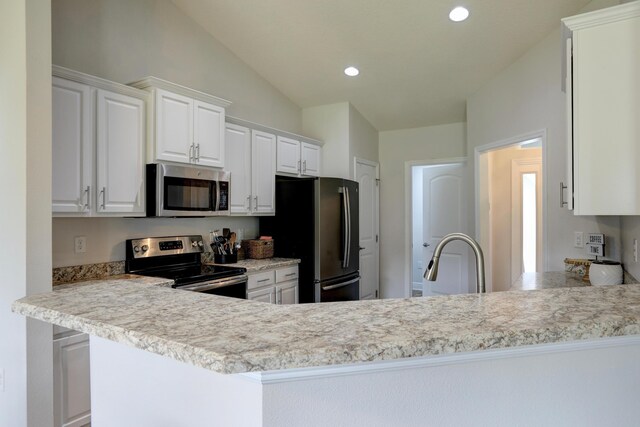 134 Day Dr, Sebastian, FL 32958 - kitchen with light countertops, a peninsula, stainless steel appliances, recessed lighting, and white cabinetry
