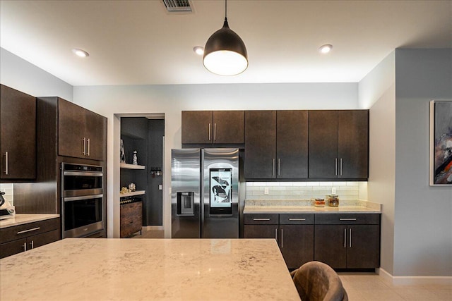 kitchen with backsplash, stainless steel appliances, dark brown cabinetry, and visible vents