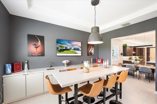 dining area with light tile patterned flooring and visible vents